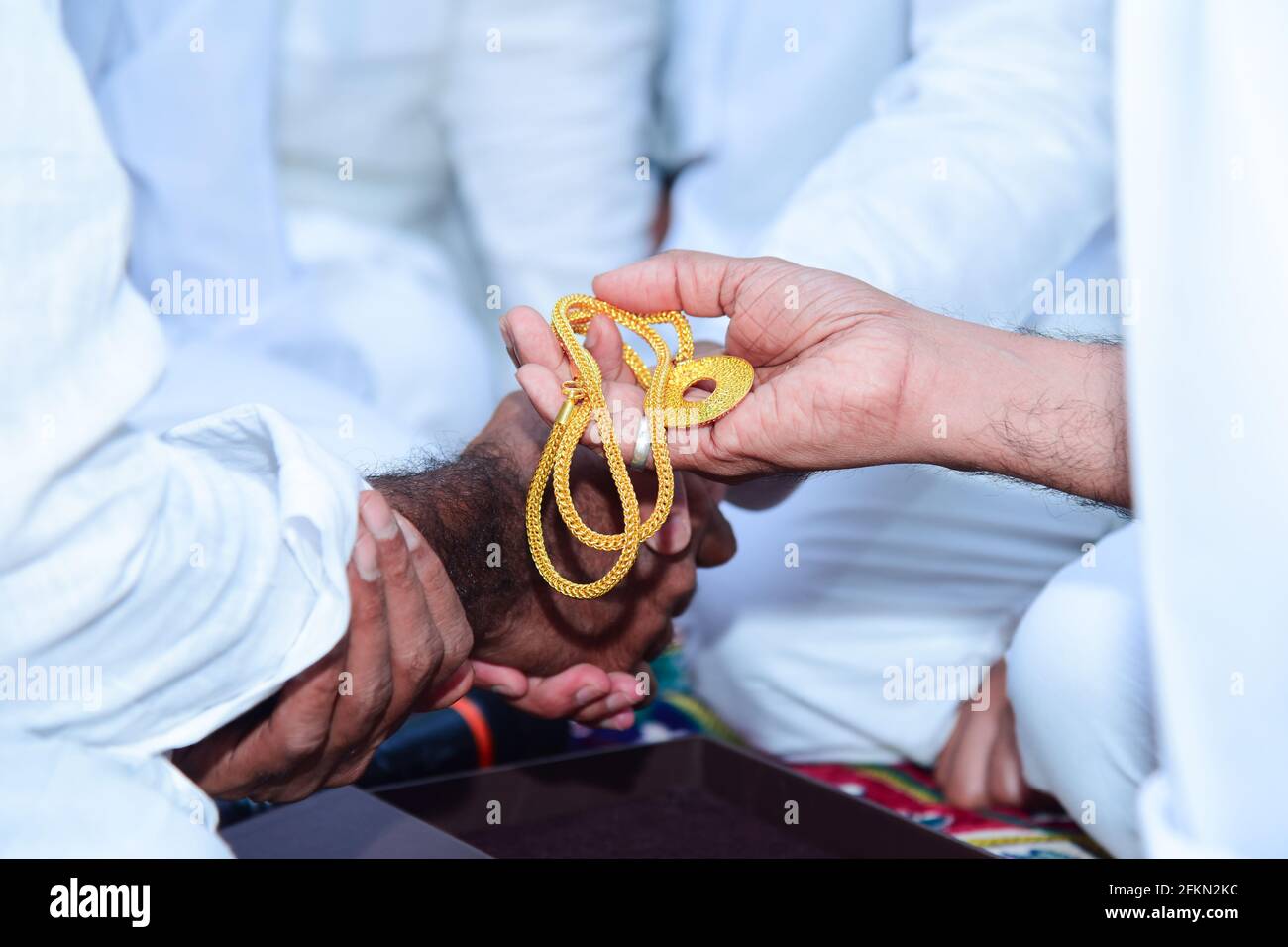 Muslim wedding nikah function in islam groom handing over gold to groom father Stock Photo