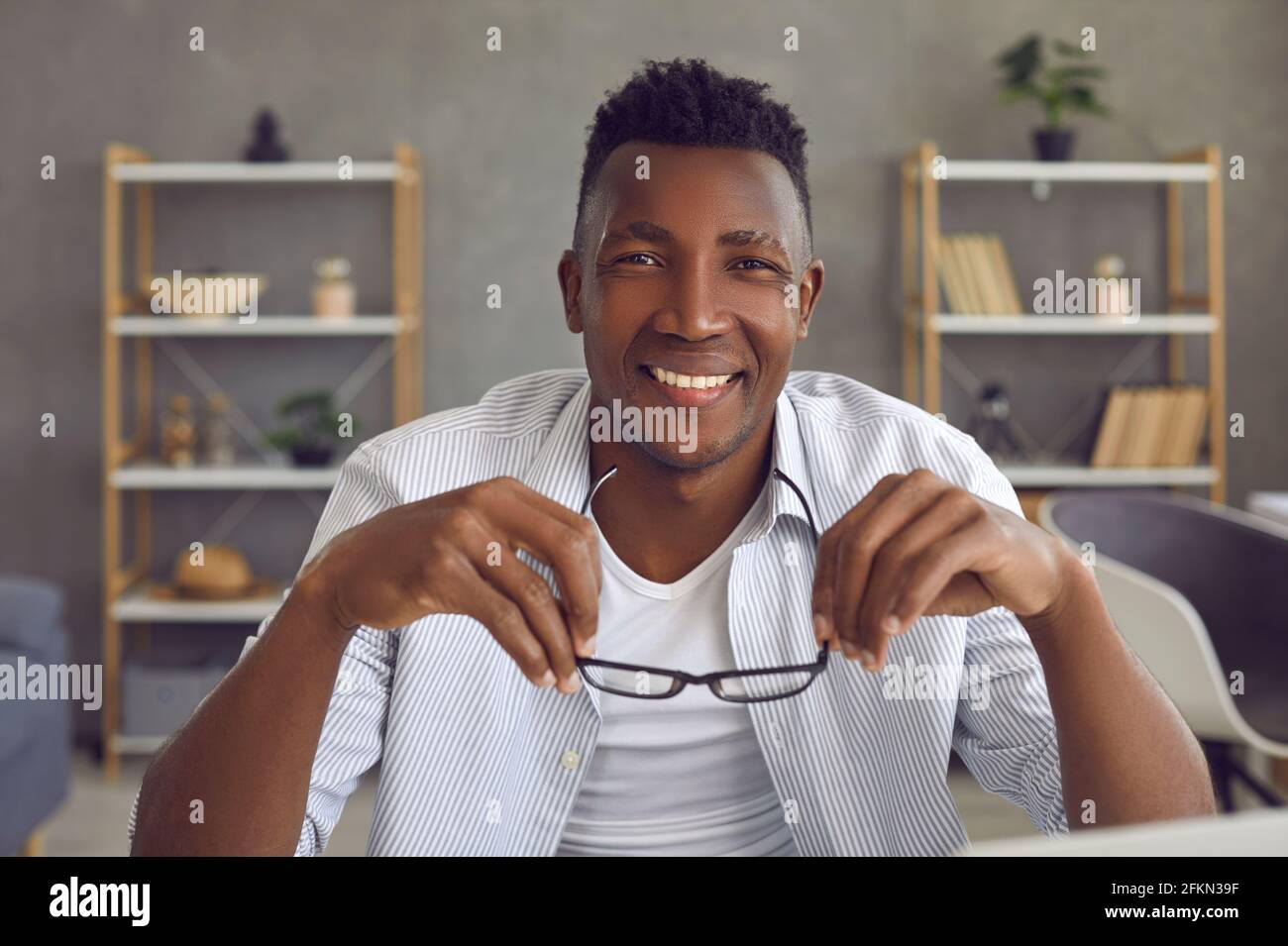 Portrait of young cheerful african american man smiling looking at ...