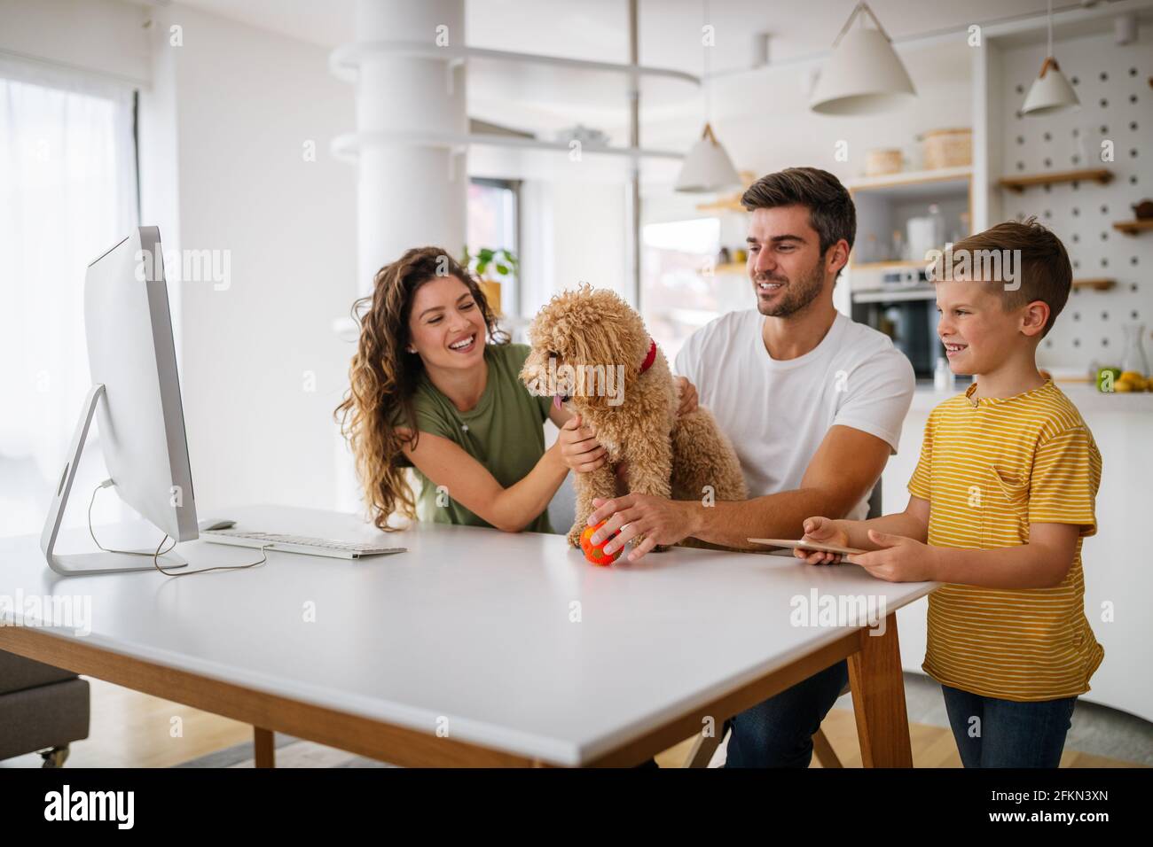 Happy modern family using computer together at home Stock Photo - Alamy