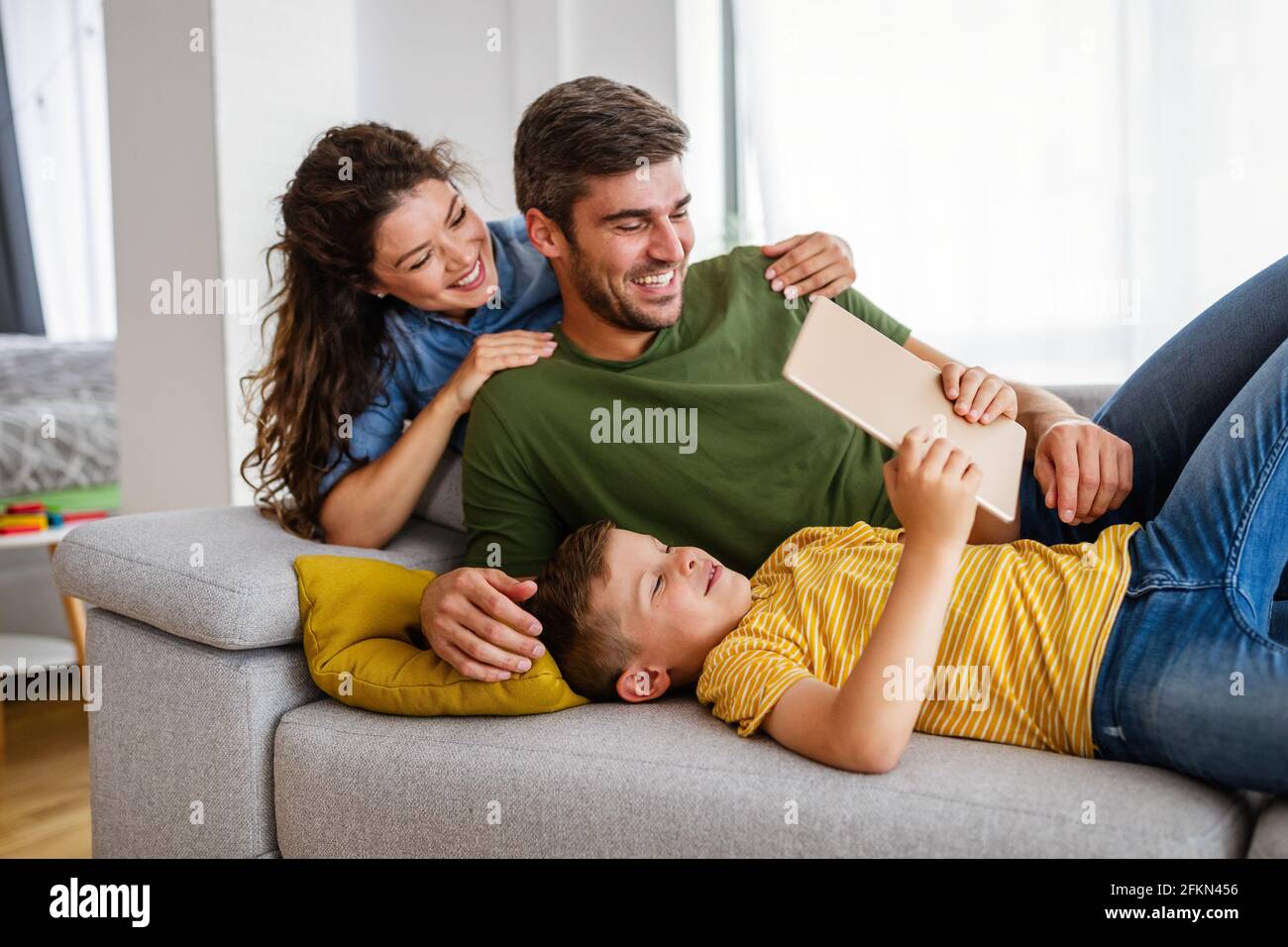 Happy modern family using computer together at home Stock Photo - Alamy