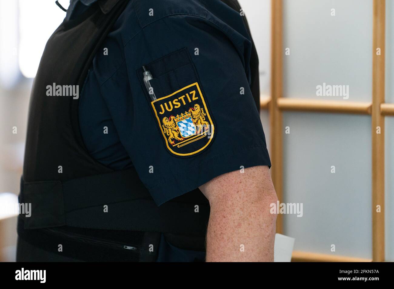 Bamberg, Germany. 03rd May, 2021. A court official stands at the entrance door to the courtroom. The trial against three former students who allegedly stole the Abitur assignments from a safe at a Bamberg high school in May 2019 has begun at the Bamberg district court. As a result, new tasks were set throughout Bavaria. Credit: Nicolas Armer/dpa/Alamy Live News Stock Photo