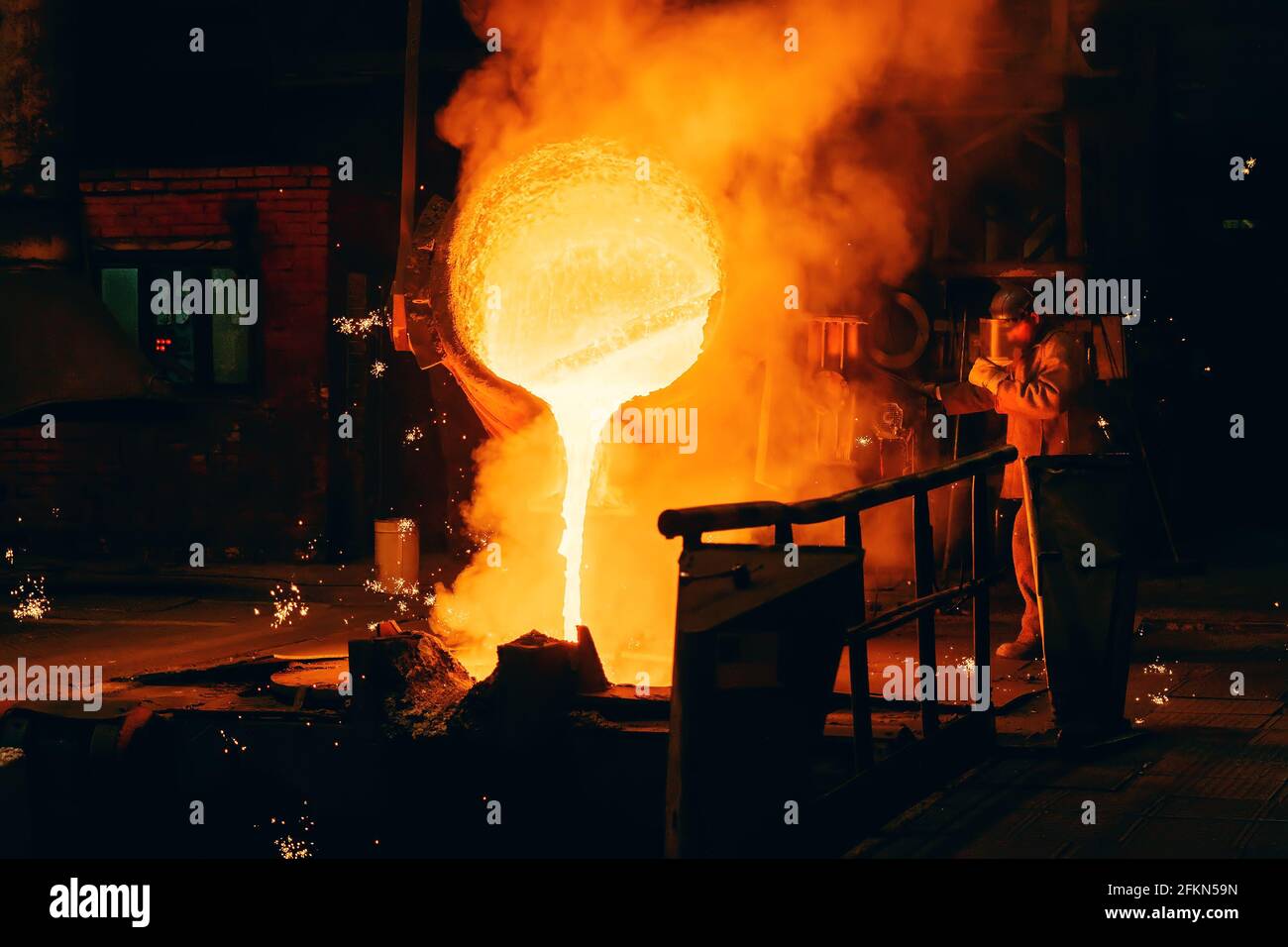 Metal Casting process in Foundry, Molten Iron pours from ladle to Blast