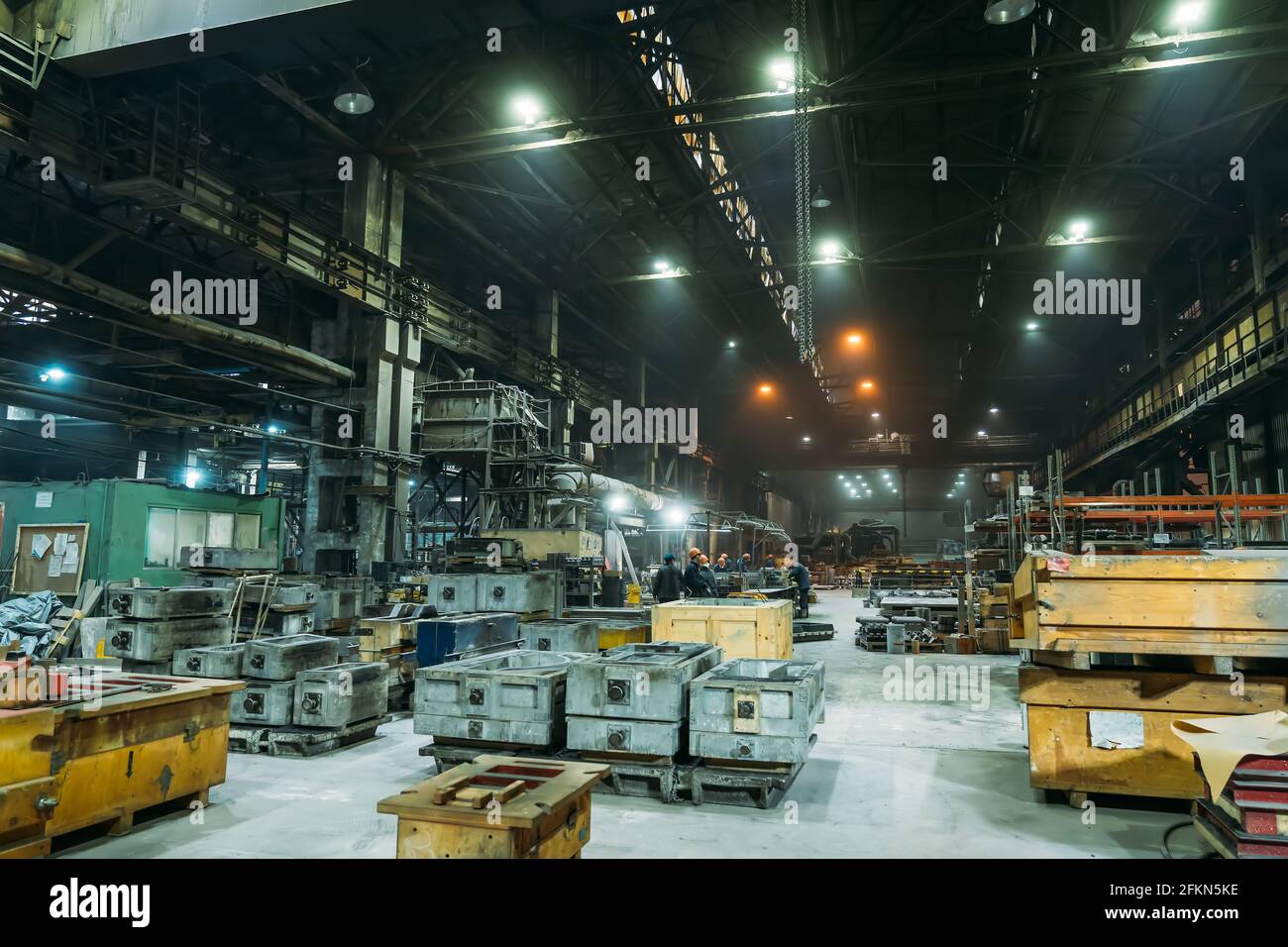 Steel Factory with workers in process of work, industrial interior, large hangar with iron production. Stock Photo