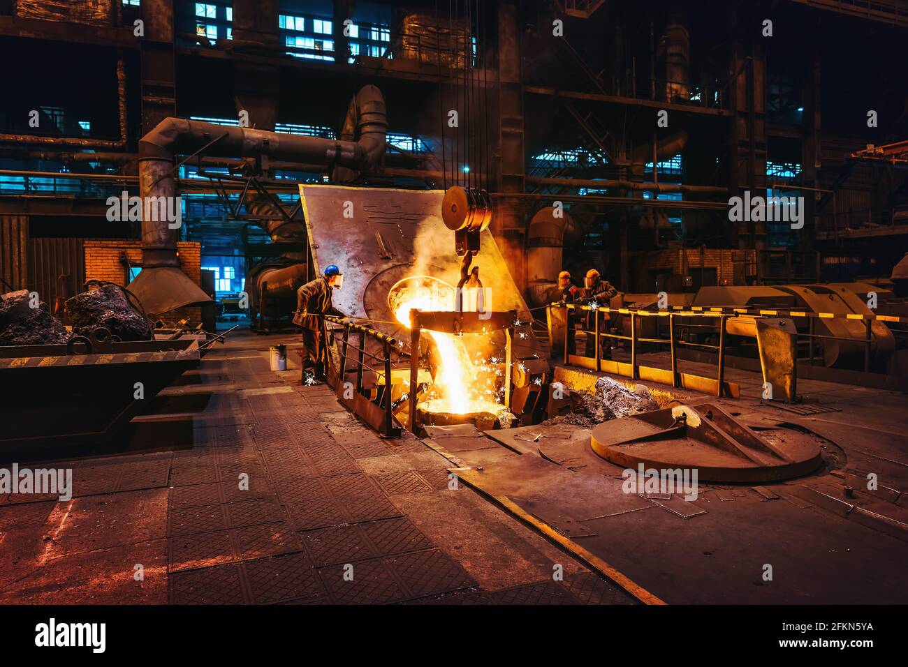 Foundry interior, molten iron pouring from blast furnace into