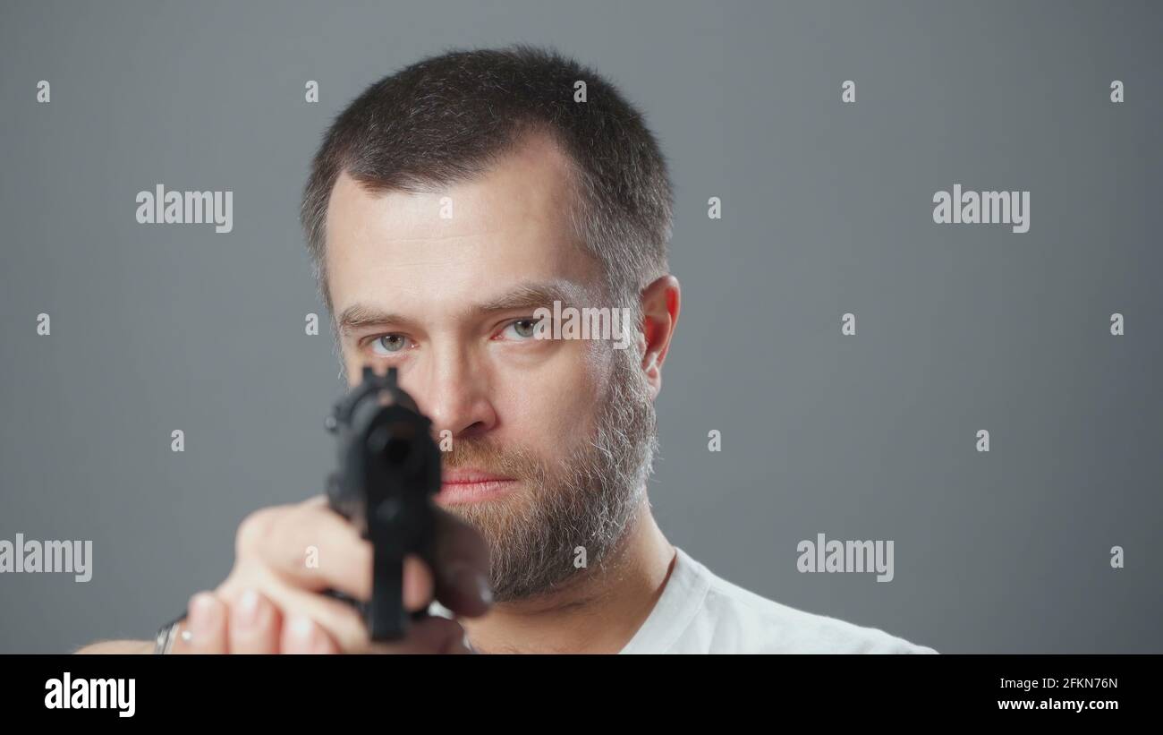 Photo of the bearded man and gunpoint Stock Photo