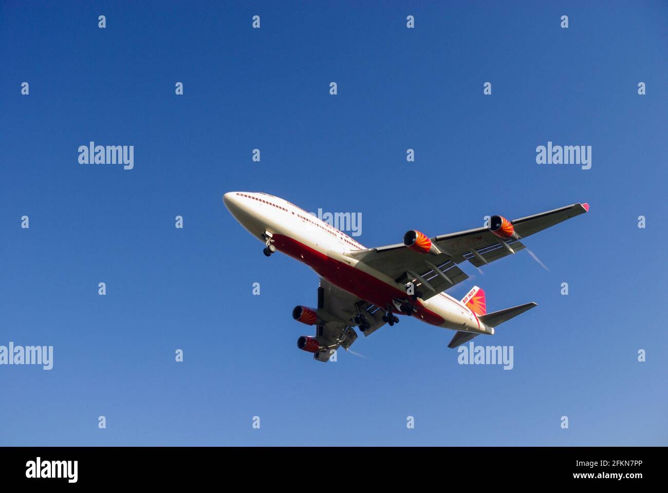 Air India Boeing 747 Jumbo jet airliner plane VT-ESM landing at London Heathrow Airport, UK, in blue sky. Approach to land. Indian airline Stock Photo