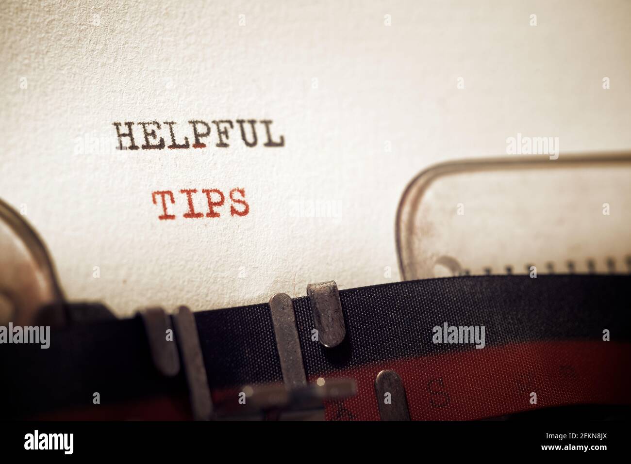 Helpful tips phrase written with a typewriter. Stock Photo