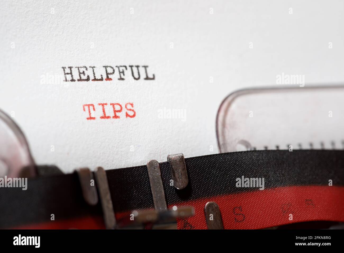 Helpful tips phrase written with a typewriter. Stock Photo