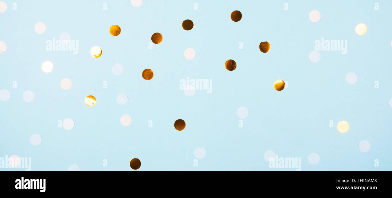 Festive light blue background with golden confetti Stock Photo