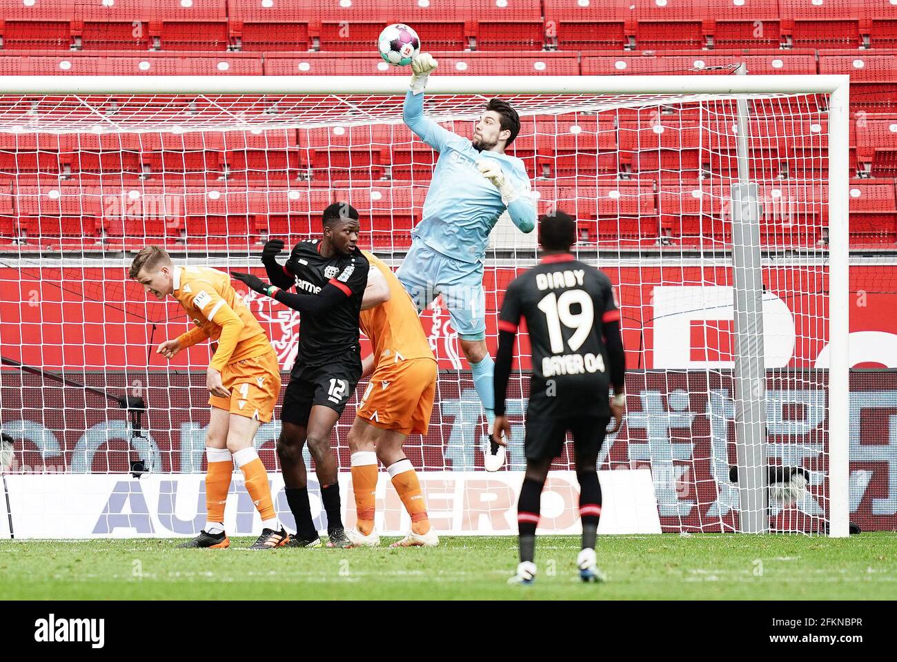 Munich's goalkeeper Stefan Ortega Moreno (R) catches the penalty shot by  Andreas Geipl of Regensburg (2-R) during the 2. Bundesliga relegation match  between Jahn Regensburg and TSV 1860 Munich at the Continental