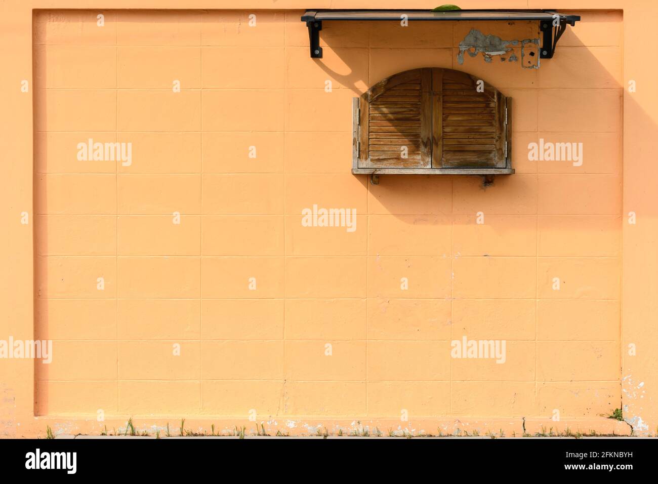 Orange colored wall and little wooden window background or backdrop