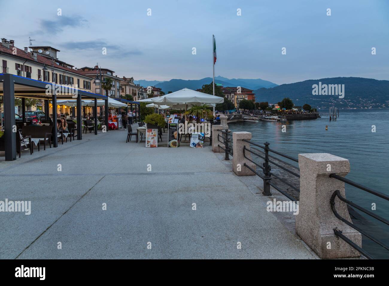 View of lakeside restaurant at dusk in Stresa, Lago Maggiore, Piedmont, Italy, Europe Stock Photo