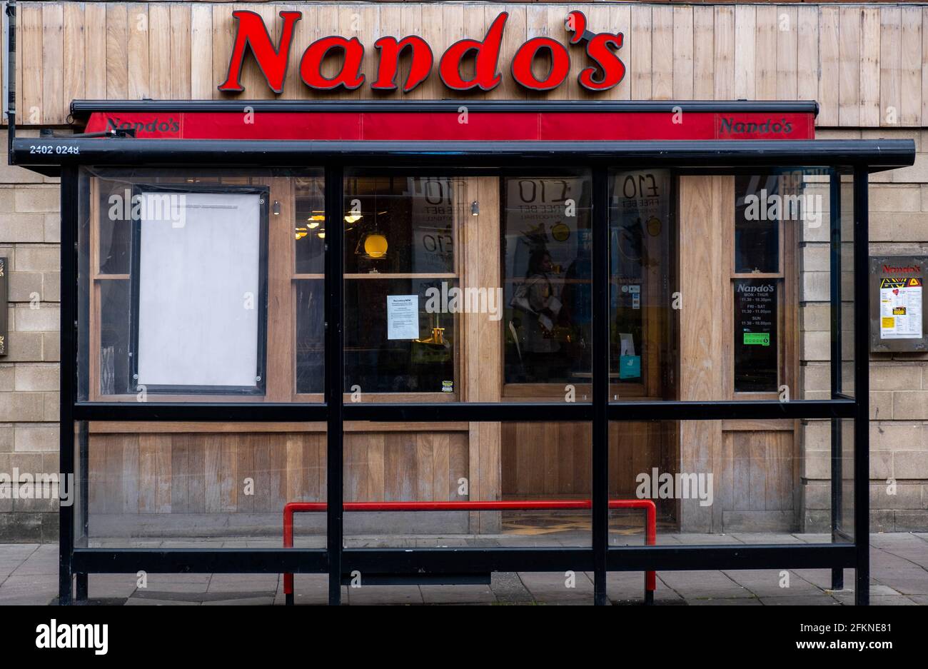 Epsom Surrey London UK, May 02 2021, Nando’s Restaurant High Street Food Chain With No People Closed During Coronavirus Covid-19 Lockdown Stock Photo