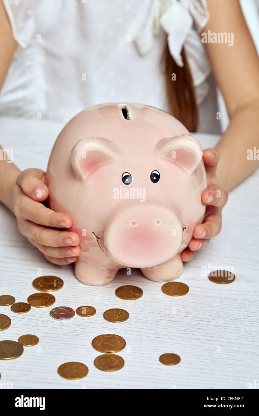 little child girl with pink piggy bank. Stock Photo