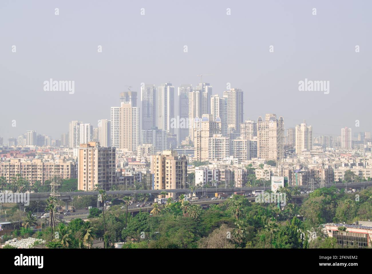 Rural to urban development of mumbai with trees and skyscrapers in ...