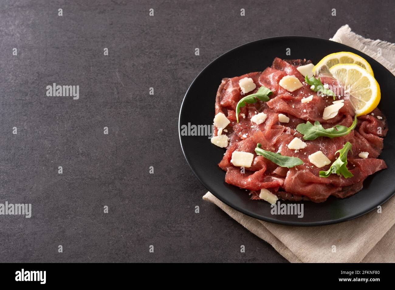 Marbled beef carpaccio on black slate background Stock Photo