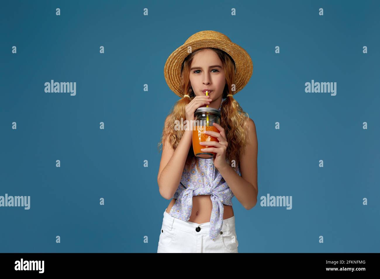 Portrait of cute little child girl drinking orange juice Stock Photo ...