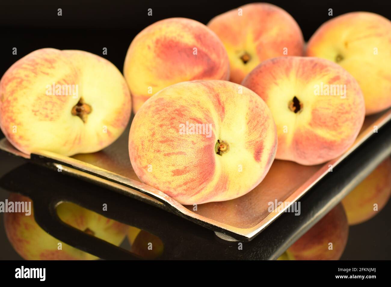 https://c8.alamy.com/comp/2FKNJMJ/several-organic-sweet-peaches-on-a-metal-tray-close-up-isolated-on-black-2FKNJMJ.jpg