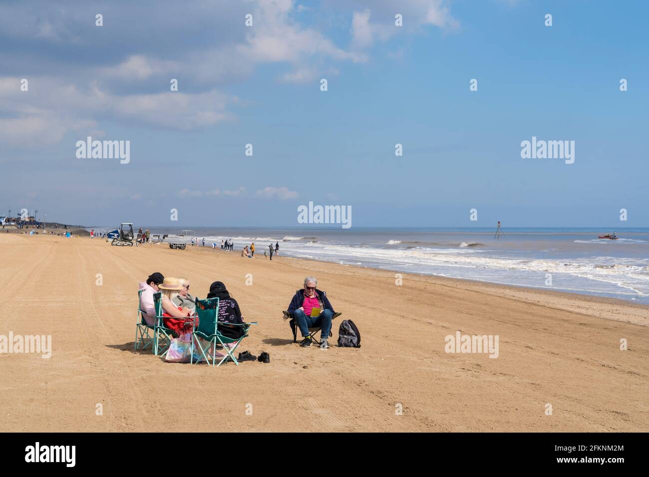 Family enjoying day out on Mablethorpe beach Lincolnshire Stock Photo