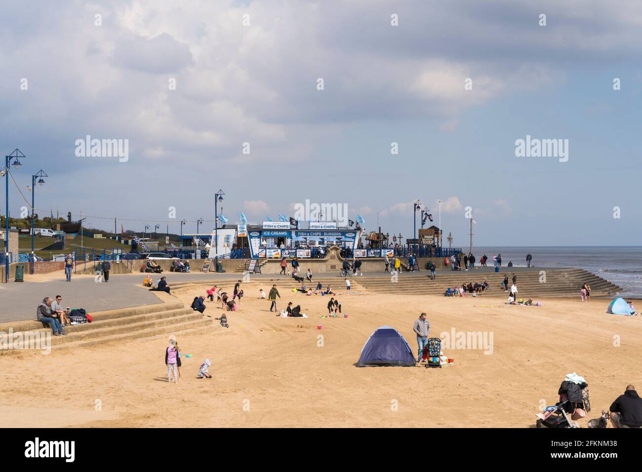 people enjoying outing after covid restrictions eased Mablethorpe beach Lincolnshire Stock Photo
