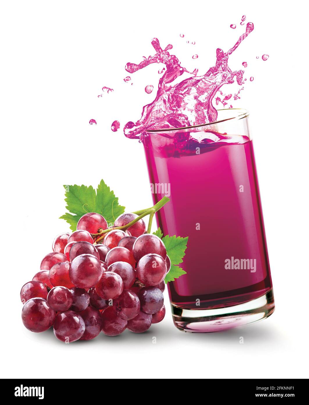 Grape juice splash out of glass with grape fruit on white background