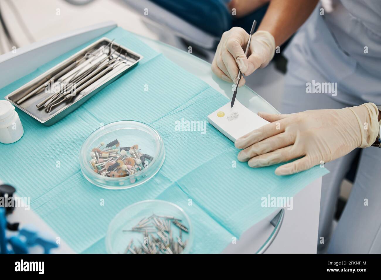 Dentist using dental spatula for creating dental filling Stock Photo