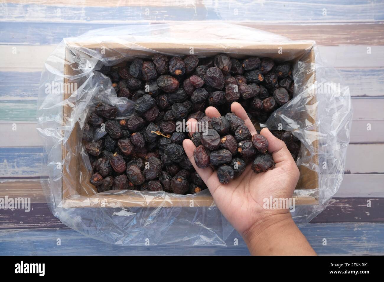 hand pick date fruit from a box top view  Stock Photo