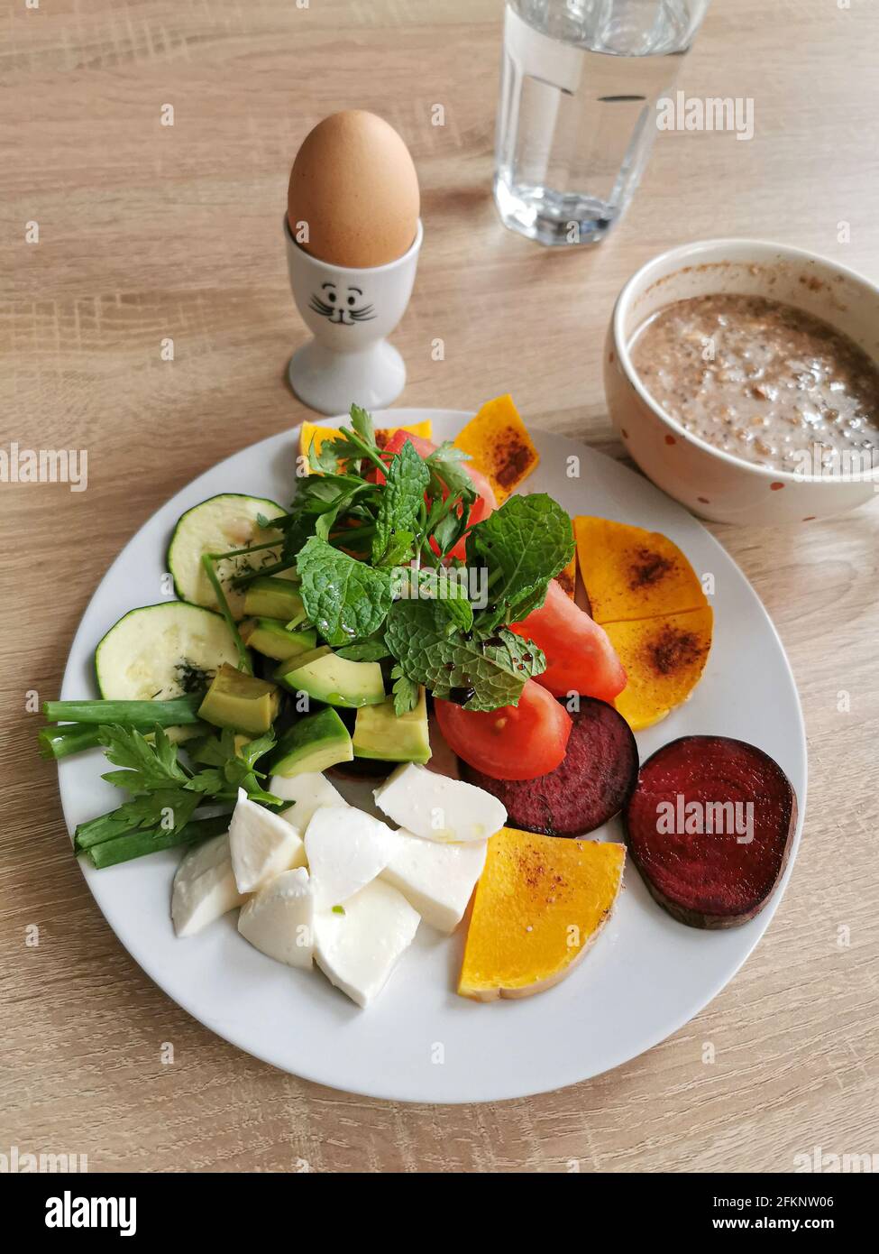 A healthy breakfast rich in protein, fats and carbohydrates. Oatmeal with nuts, softboiled egg