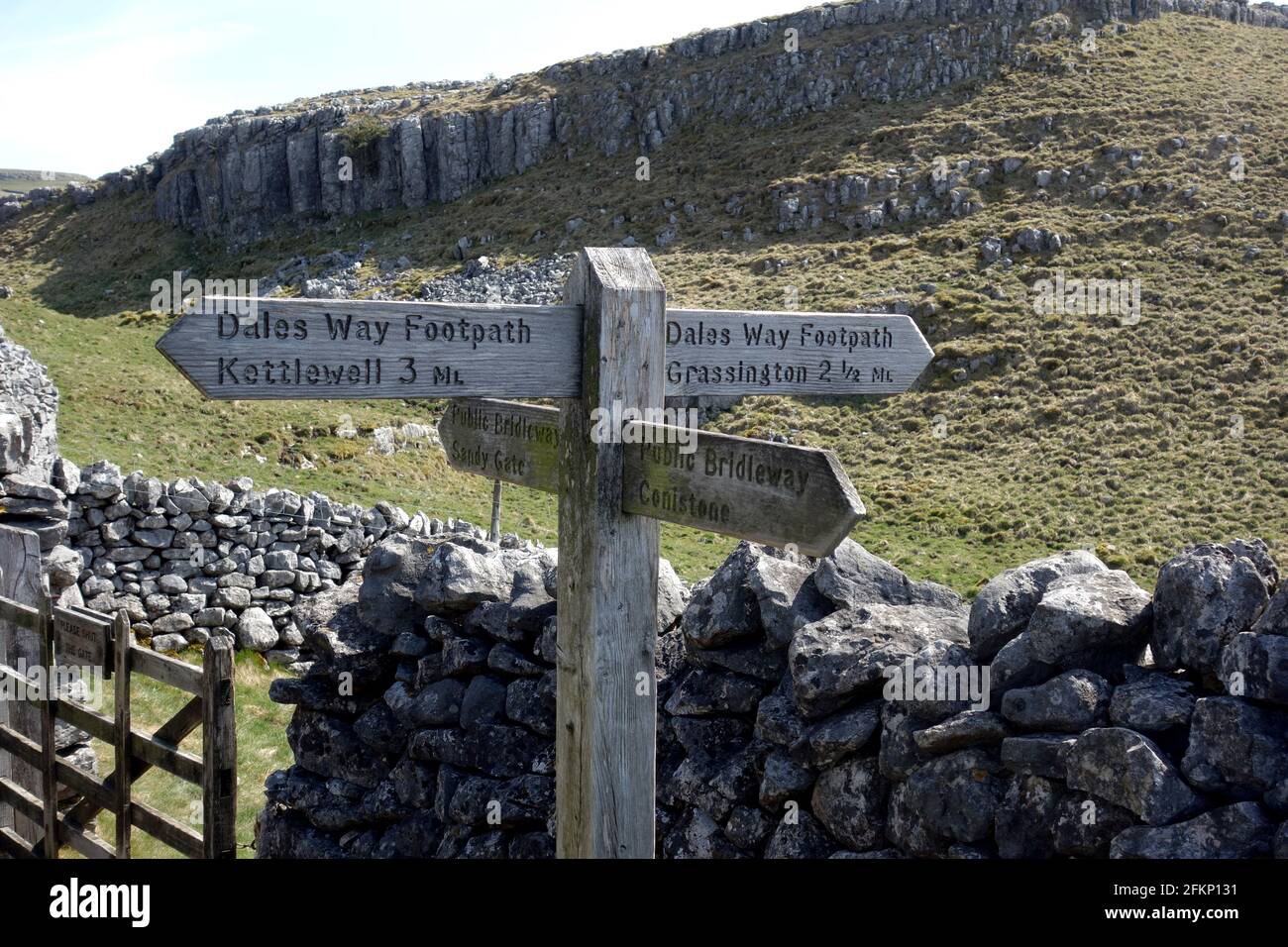 Wooden Signpost to Kettlewell & Grassington near Conistone on the Dales Way Long Distance Path in the Yorkshire Dales National Park, England, UK. Stock Photo