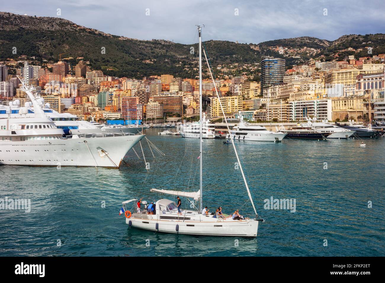 Principality of Monaco city skyline, sailboat and yachts in Port Hercules Stock Photo