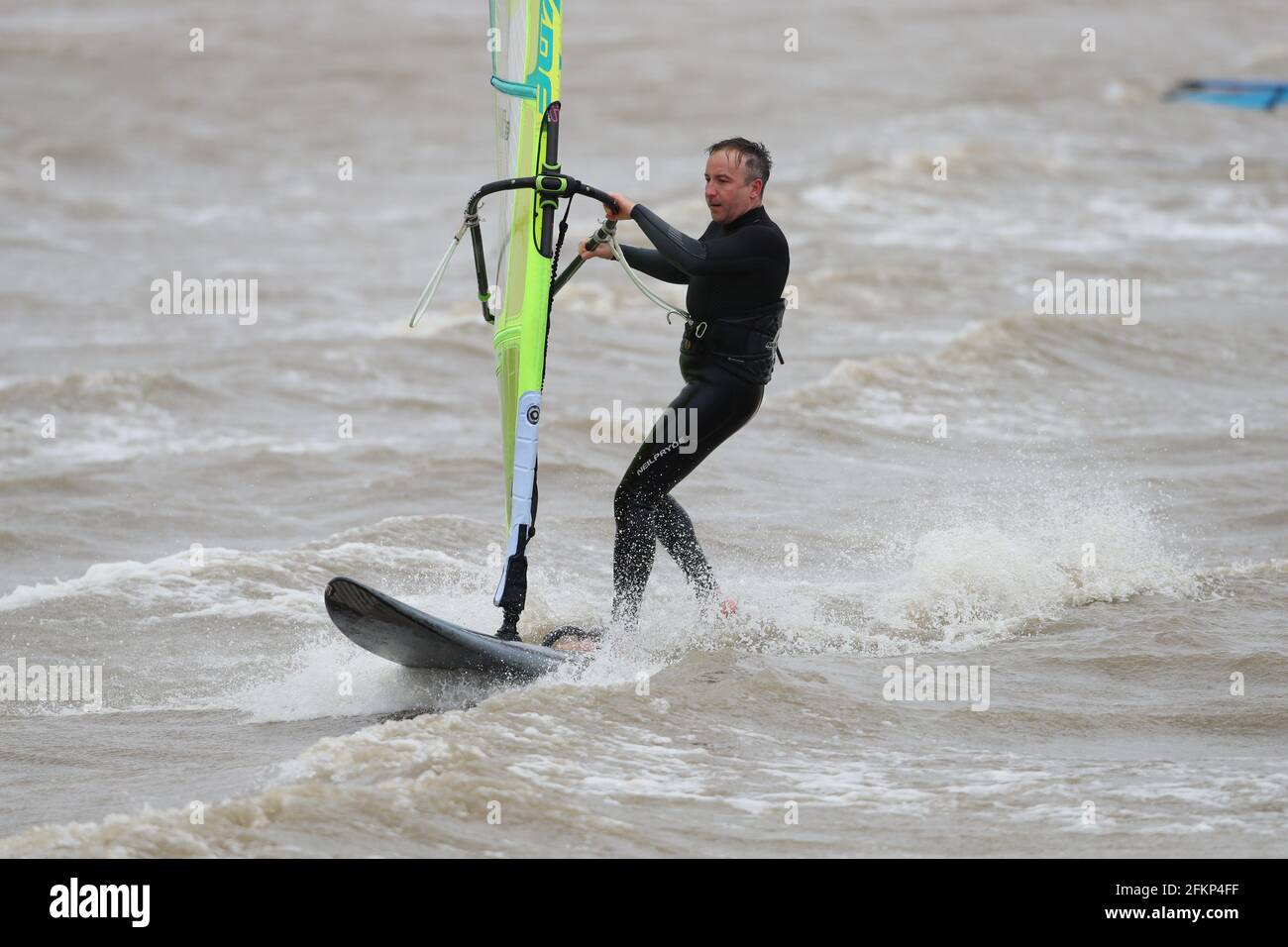 New Forest, Hampshire. 3rd May 2021. UK Weather. Wind surfers make the most of the strong winds in The Solent off Calshot Beach in the New Forest with gusts up to 40 mph. Credit Stuart Martin/Alamy Live News Stock Photo