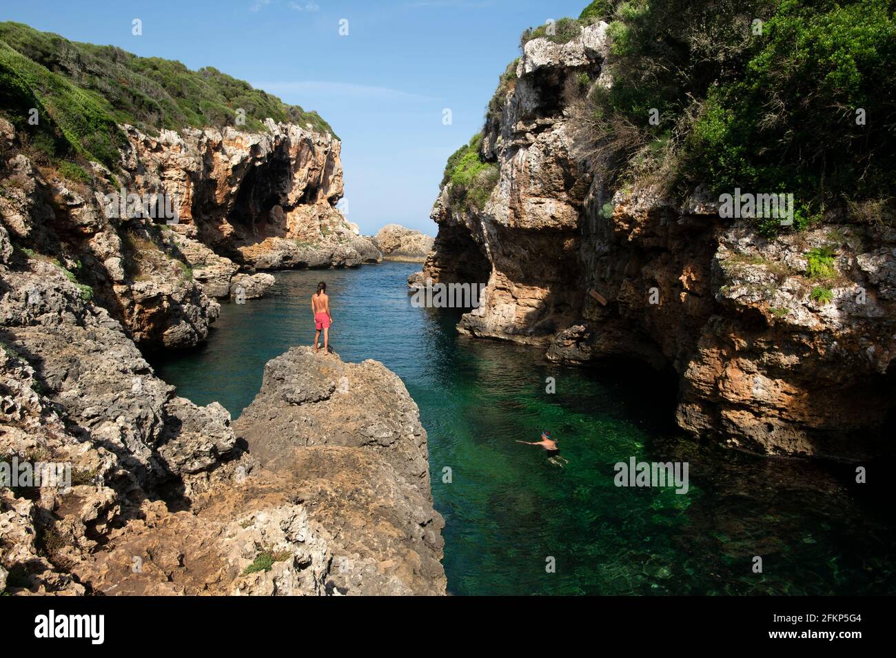 swimming in the beautful rocky cove of cala rafalet on menorca spain Stock Photo