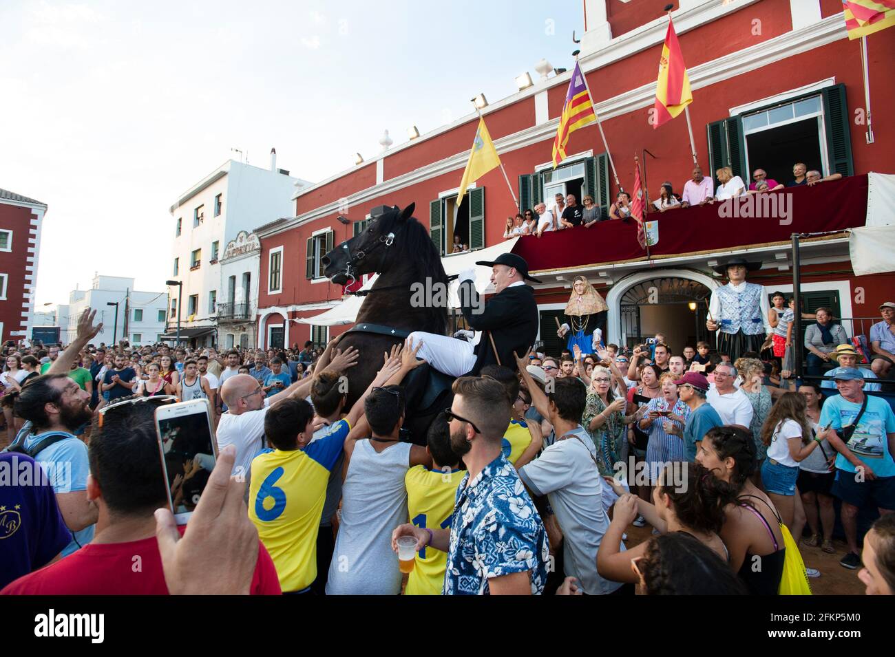 Horses surrounded by festival crowds in es castell during the festival of st joan menorca Stock Photo