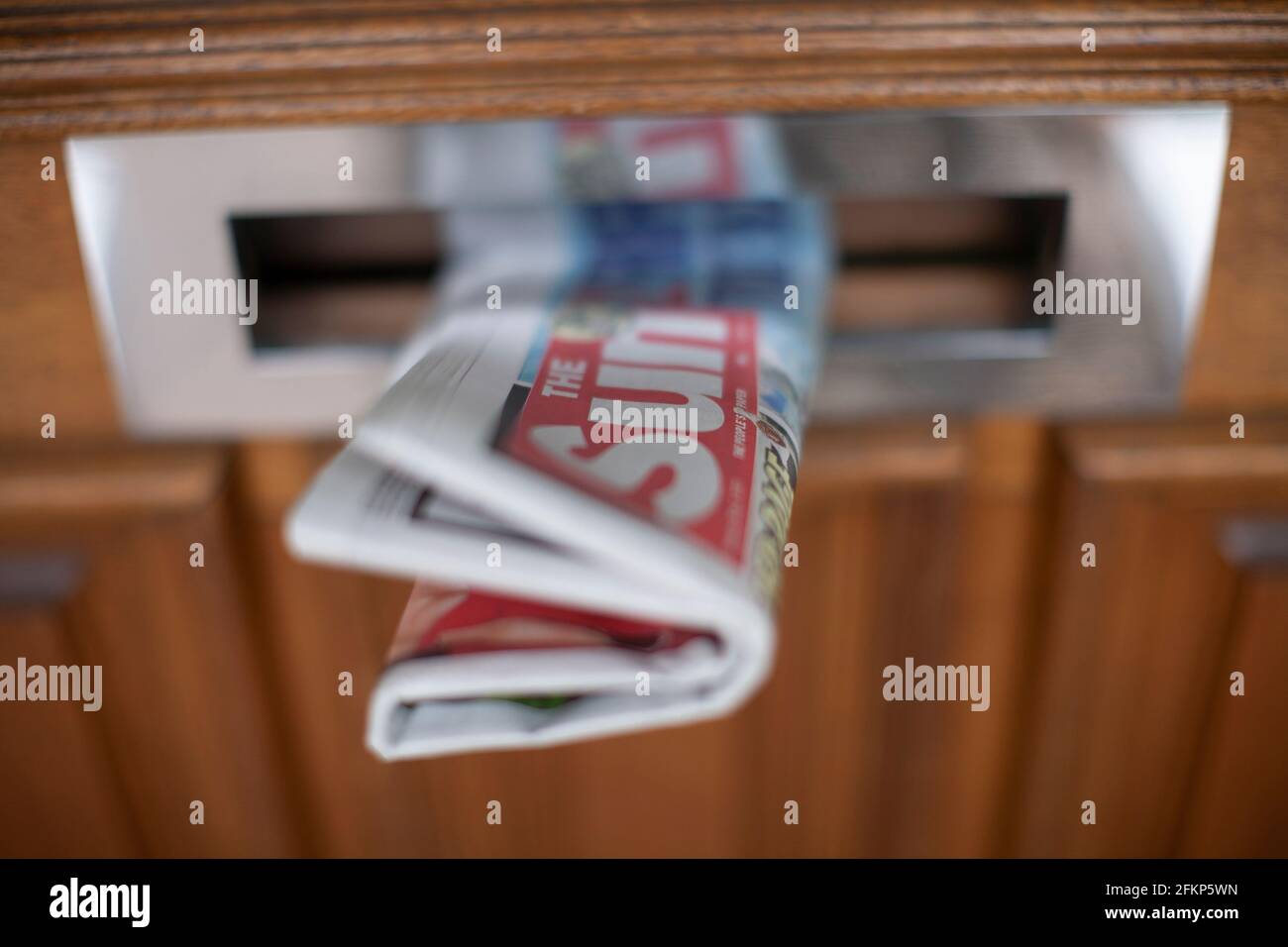 The Sun National daily paper in letterbox Stock Photo