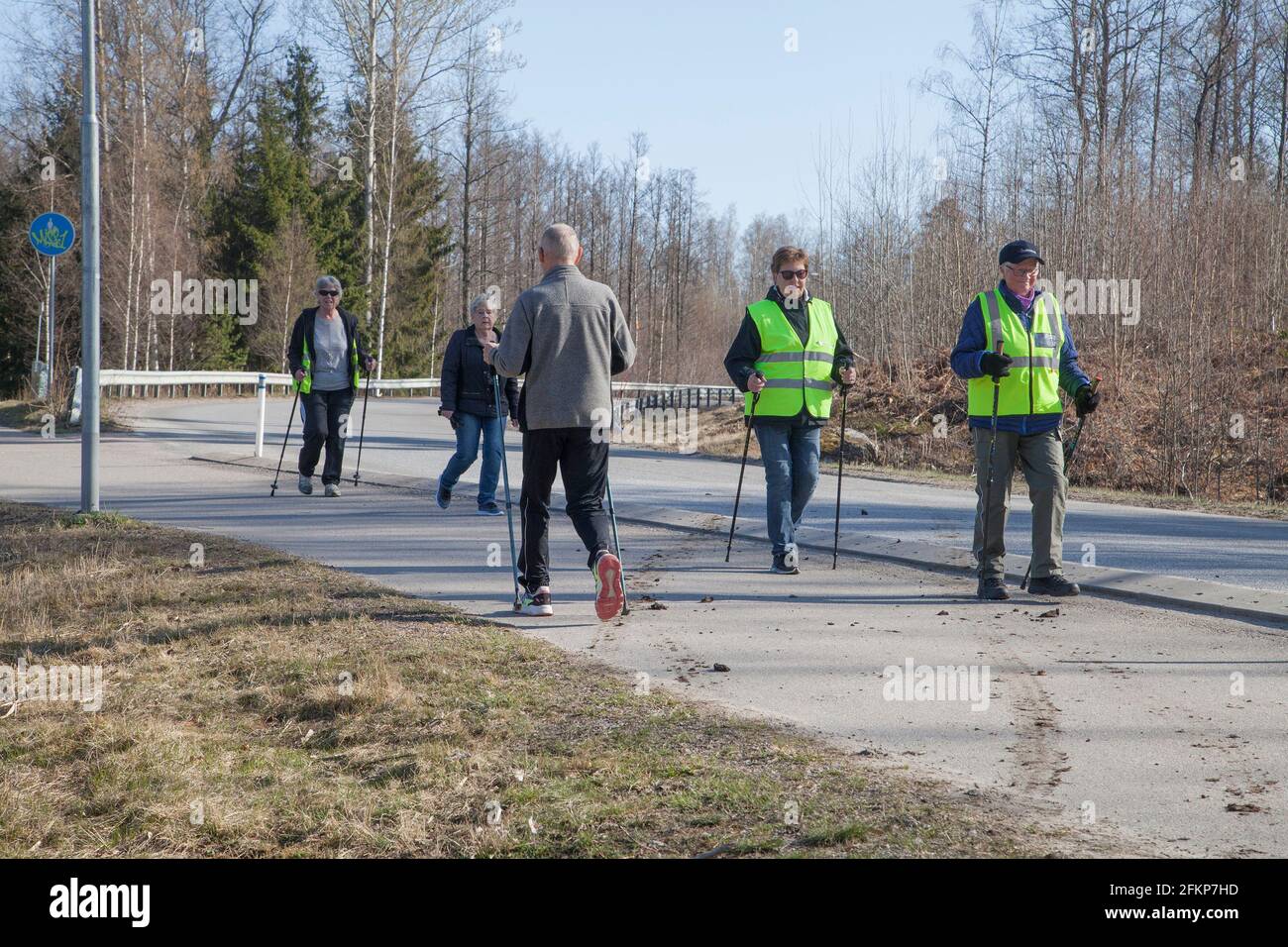 NORDIC WALKING group of senior citizens exercise Stock Photo