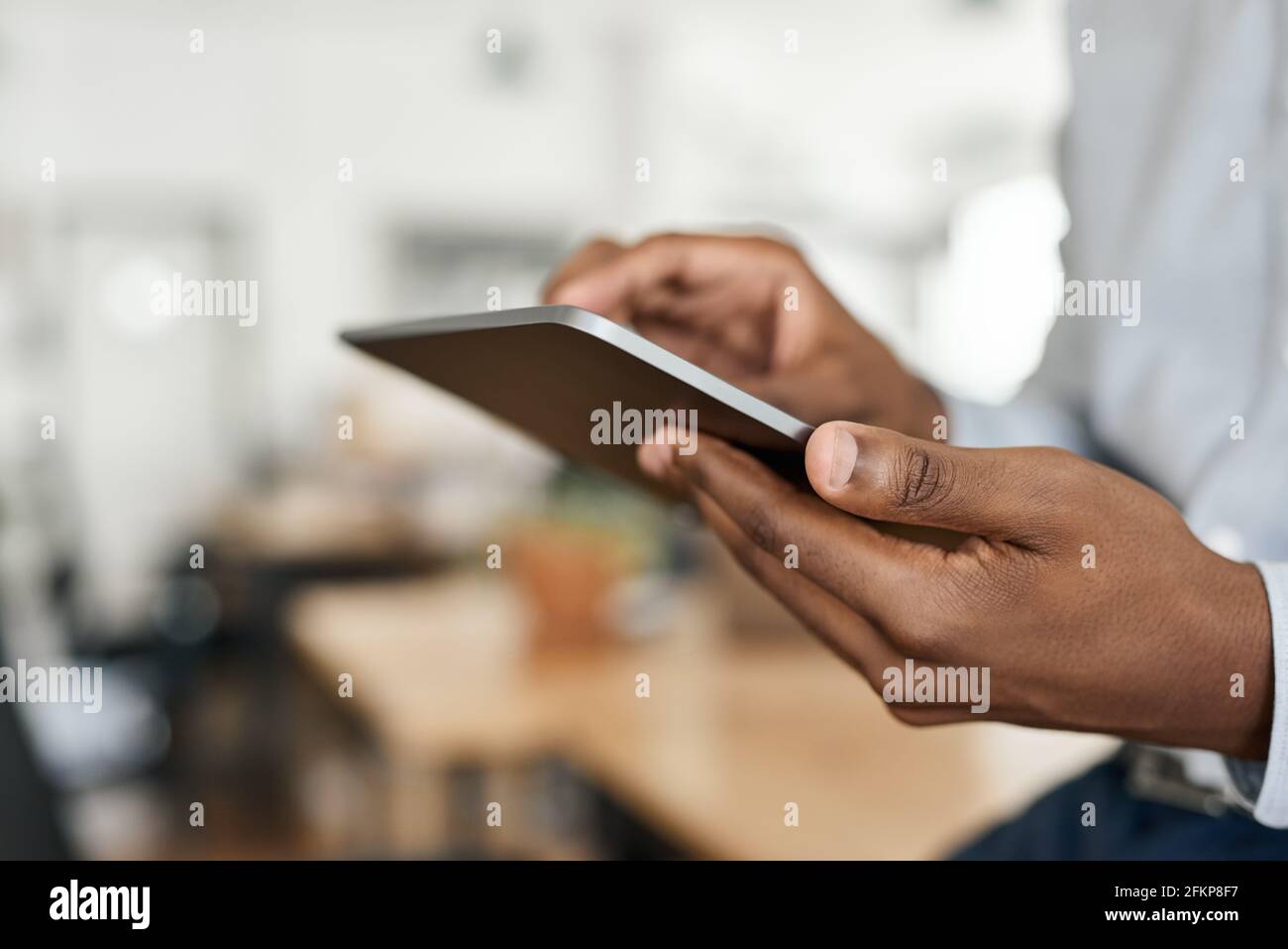 Closeup of an African businessman using a digital tablet Stock Photo