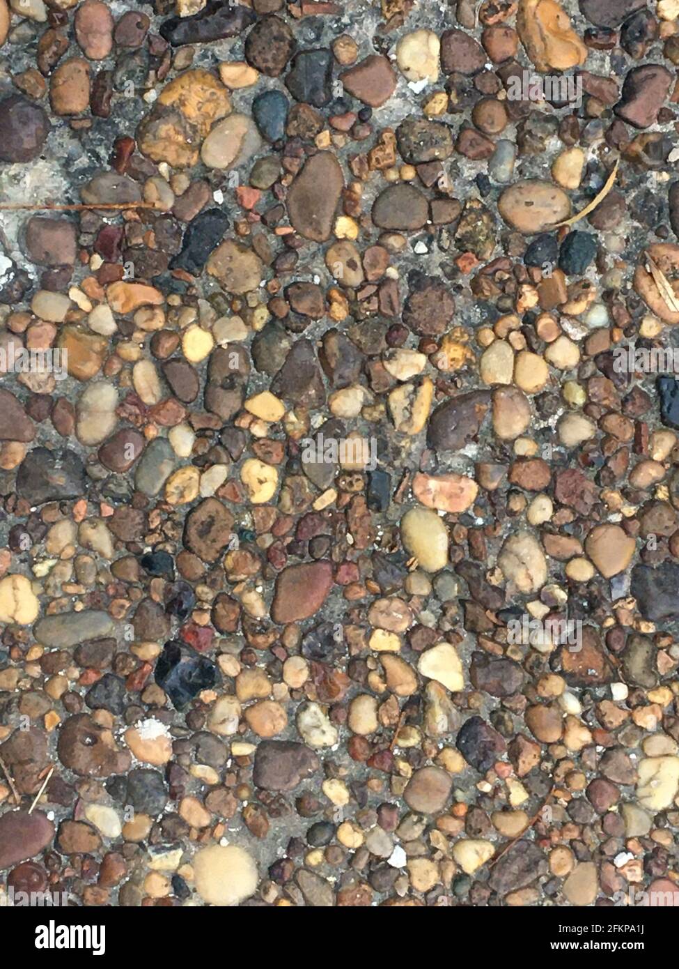 Natural river stone pebble pavement texture background Stock Photo