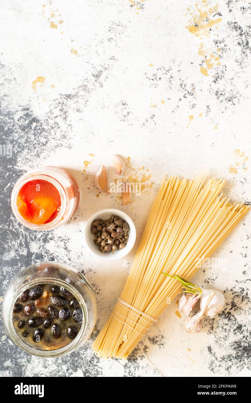 Some ingredients to make puttanesca pasta, a typical italin dish. Copy space Stock Photo