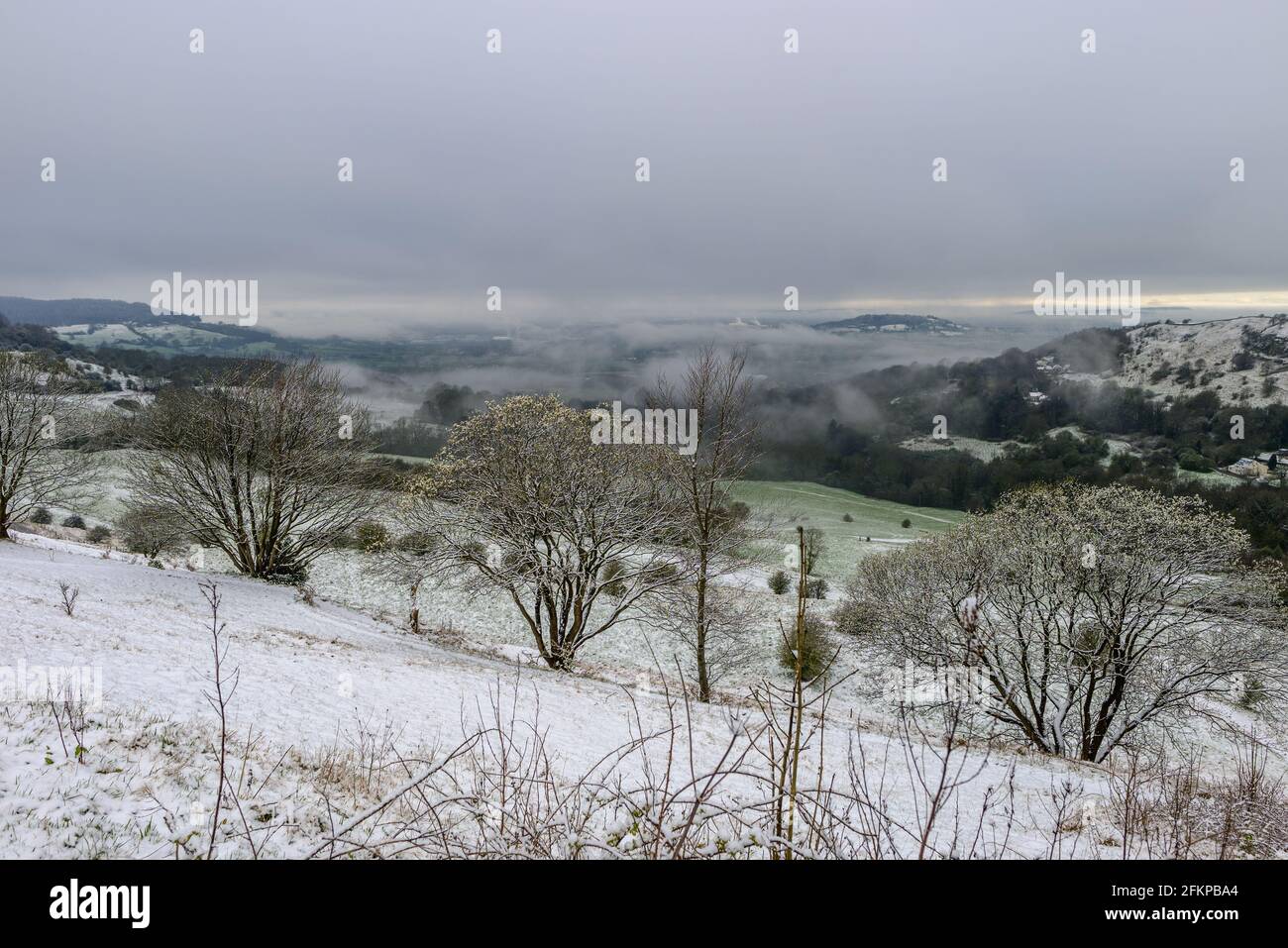 Birdlip, Cotwolds, Gloucestershire, UK with snow in April. View across the Avon Valley. Stock Photo