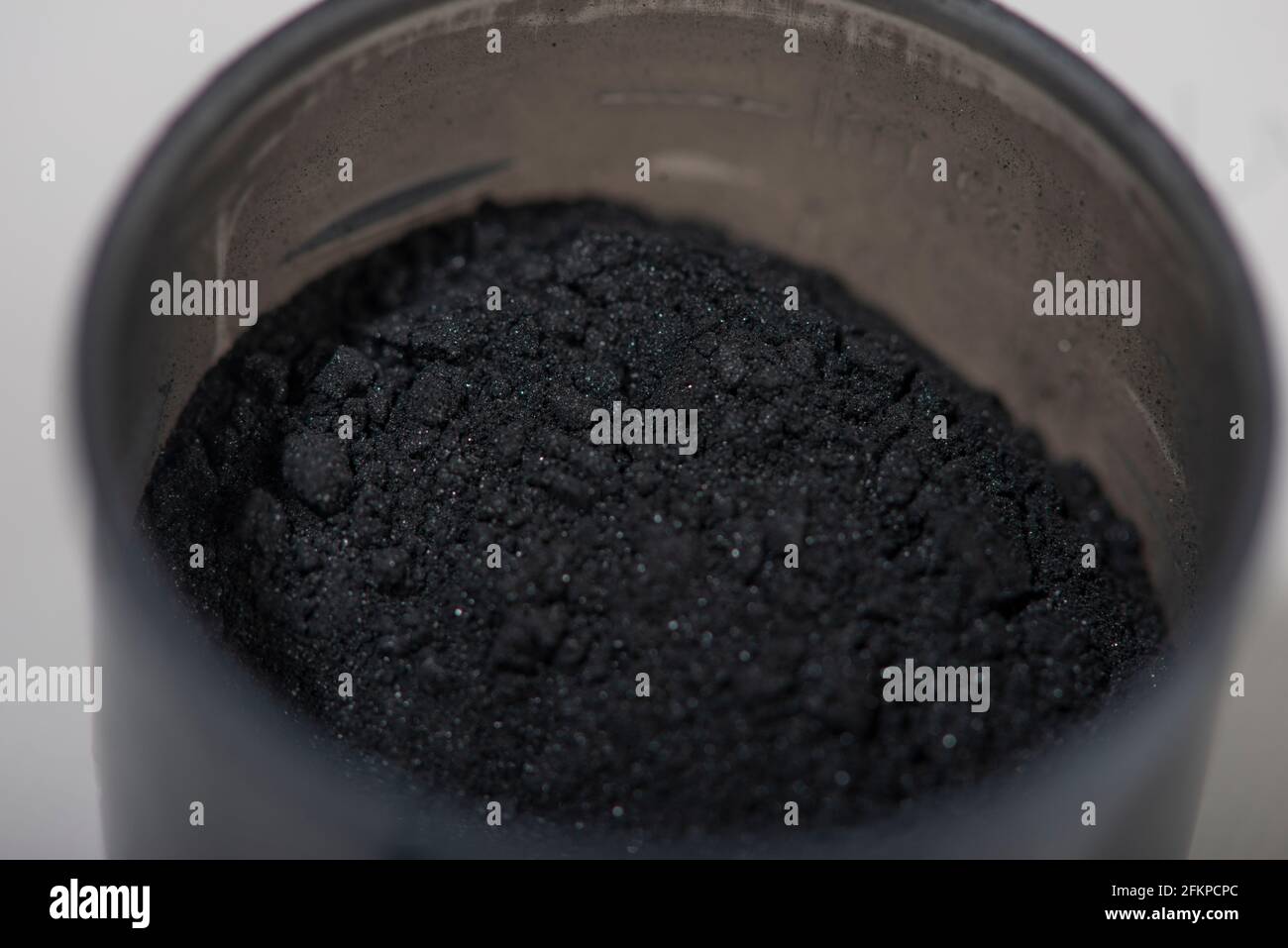 Activated charcoal powder for facial mask. Natural beauty treatment and spa. Beauty concept. Close up. Selective focus. Stock Photo