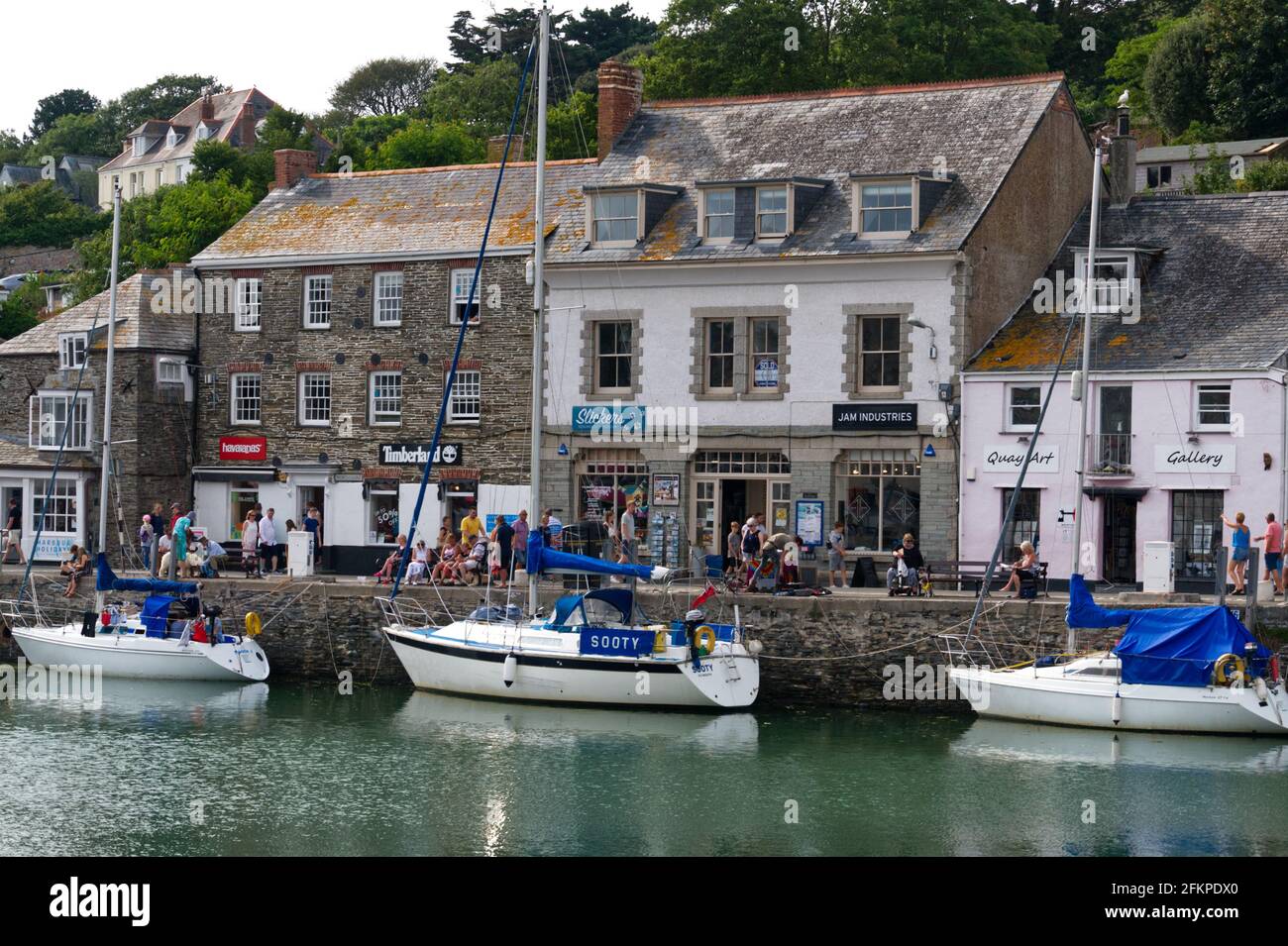 Buildings and Shops line the harbour in the picturesque coastal village of Padstow, Cornwall, England, UK Stock Photo