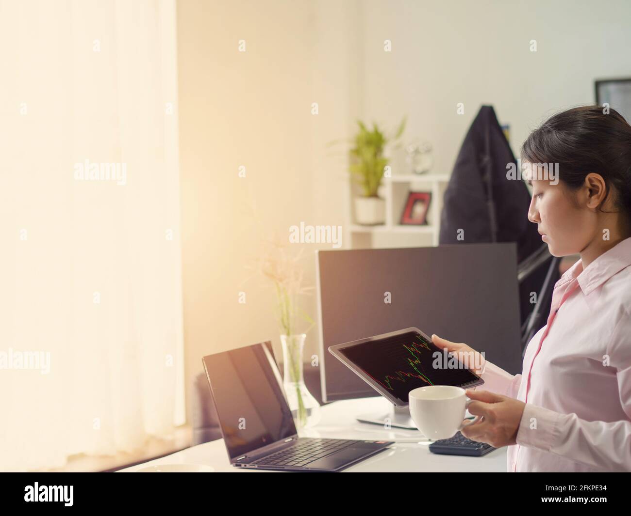 business woman trading forex stock, trading forex in tablet platform and destop Stock Photo