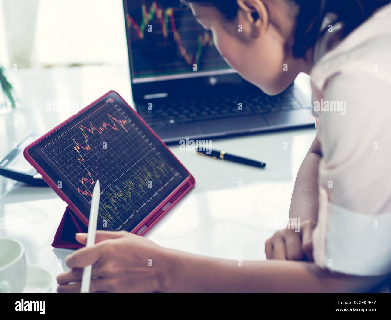 business woman trading forex stock, trading forex in tablet platform and destop Stock Photo