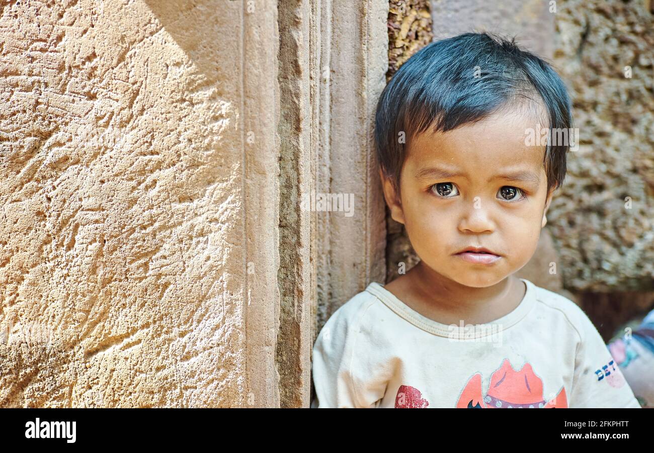 Portrait of a cute child at Banteay Srey temple. Siem Reap. Cambodia Stock Photo