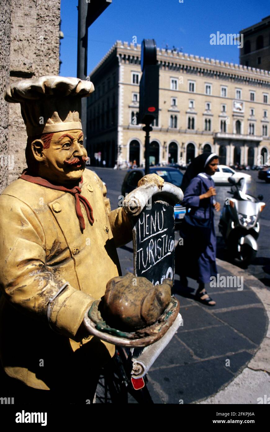 A nun wals by a 'Menu Turistico' restaurant sign at the Piazza Venezia, Rome, Italy. Stock Photo