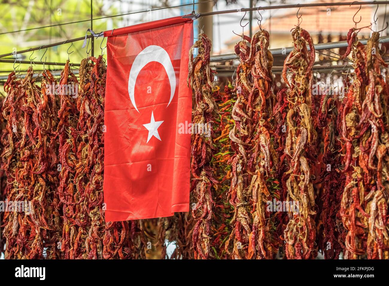 Turkish flag and dried chili pepper hanging on the market Stock Photo