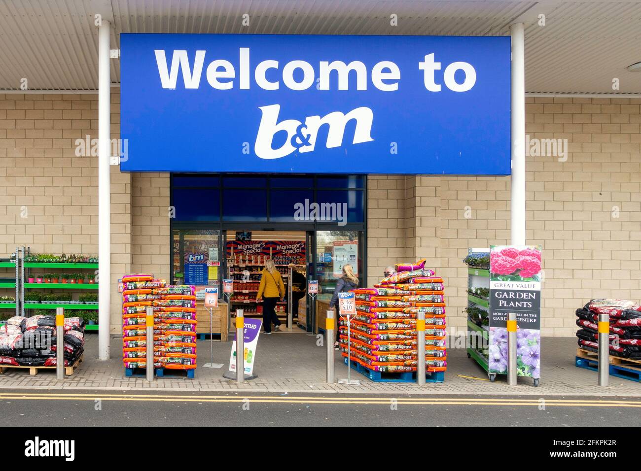 to B&M store supermarket entrance with a woman entering and