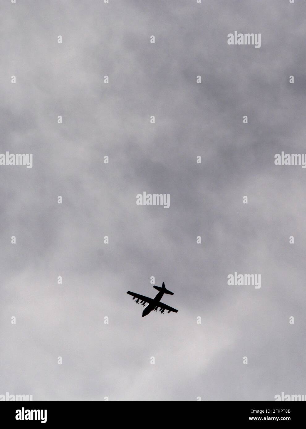 A  U.S. military Lockheed C-130 Hercules Air Force cargo plane approaches its destination at Kirkland Air Force Base in Albuquerque, NM. Stock Photo