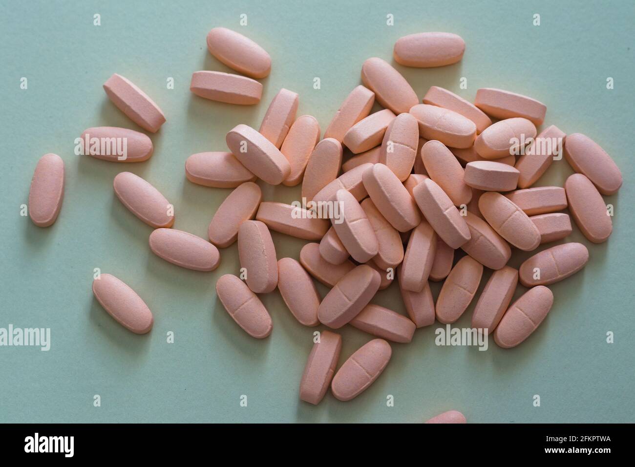 Pink pills on grey background Stock Photo