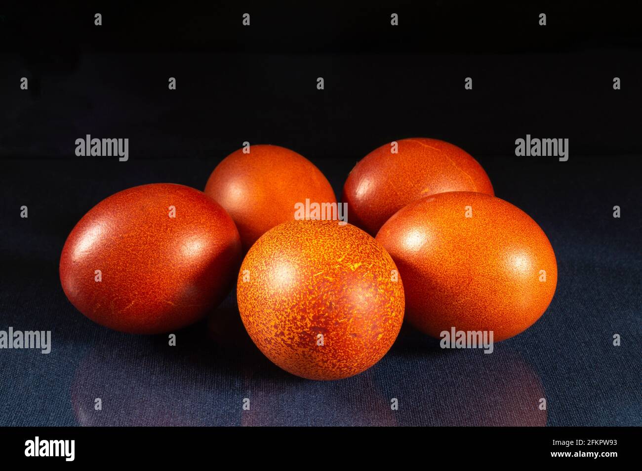 Painted chicken eggs on the table with a reflection. Food on a black background Stock Photo